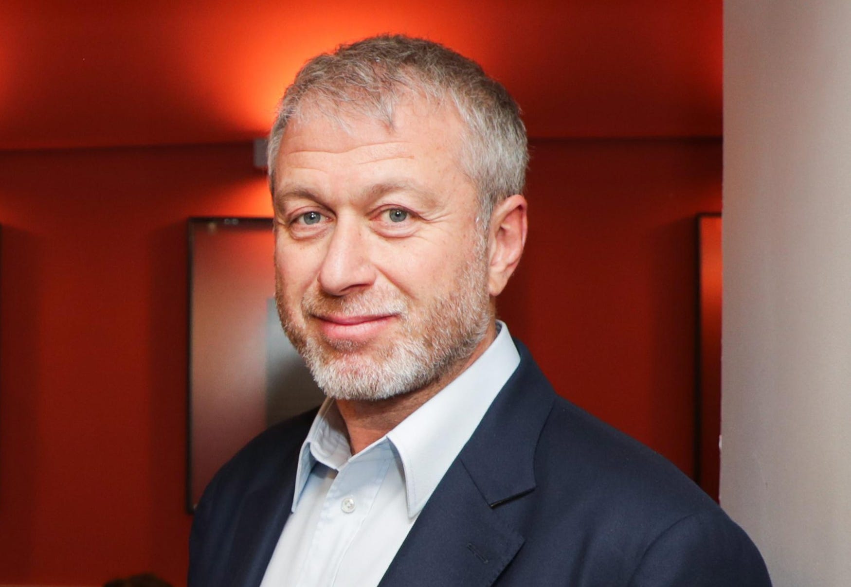 Roman Abramovich in a formal suit, looking composed and confident—symbolizing his global influence in business, sports, and philanthropy support an article by Thomas McCorry