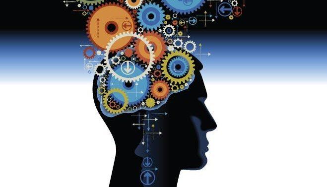 Silhouette of a human head filled with colorful gears, symbolizing complex thinking, strategic cognition, and mental model frameworks.