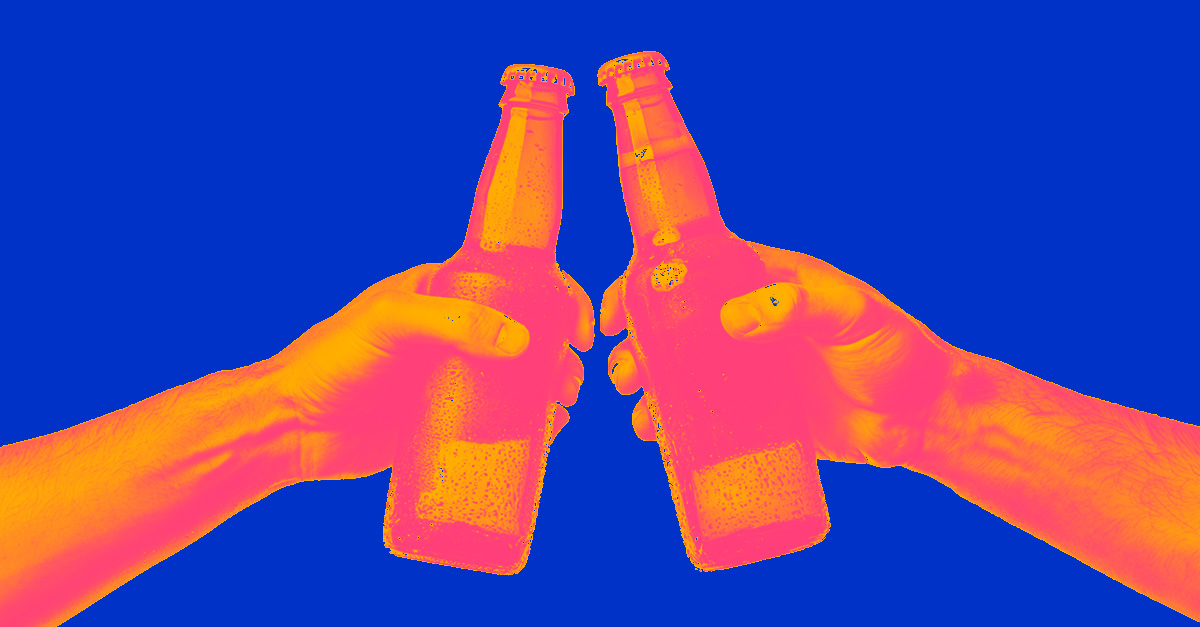 two non-descript bottles held by hands doing cheers to symbolize brand building in beverage alcohol