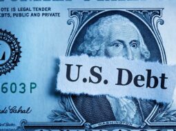 US dollar bill with a sign that says US Debt